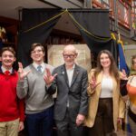 How UofL is honoring the nation’s 250th anniversary Individuals hold up the L sign with a copy of the Declaration of Independence on display in the background.