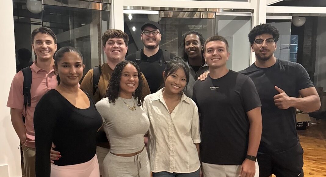 UofL students use AI to create software tools and companies A group of college students in an indoor area