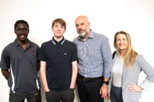Cardinals Rising ambassador Emmanuel Edwards pictured with participating student Liam Knaebel and his parents, Bucky and Jennifer Knaebel. Photo credit: Tom Fougerousse