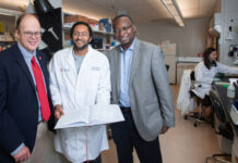 New federal designation elevates UofL physician-scientist training program Three men standing in a medical research laboratory.
