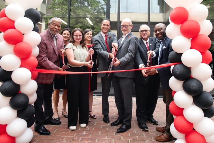 Ribbon Cutting Members of the Louisville community cut a ribbon in front of the Bingham Humanities Building.