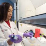 Woman at laboratory hood.