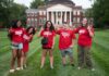 What’s new this fall, Cards? Students in red shirts stand in front of Grawemeyer Hall