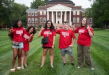 What’s new this fall, Cards? Students in red shirts stand in front of Grawemeyer Hall