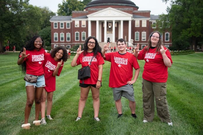 Welcome Week 26 Students in red shirts stand in front of Grawemeyer Hall