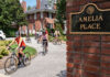 Provost and Cardinals bike out of Amelia Place's drive way/