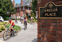 Provost and Cardinals bike out of Amelia Place's drive way/