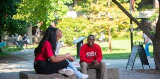 UofL named one of America’s Best Colleges for ROI Students talking together on campus.