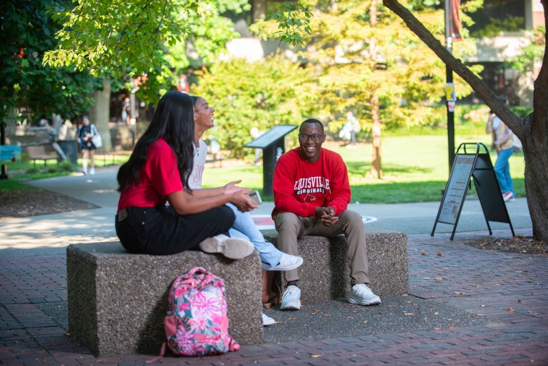 UofL named one of America’s Best Colleges for ROI Students talking together on campus.