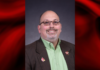 UofL names Charlie Perusse as inaugural chief transformation officer Portrait of a man wearing a green shirt in a red and black graphical template