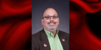 UofL names Charlie Perusse as inaugural chief transformation officer Portrait of a man wearing a green shirt in a red and black graphical template