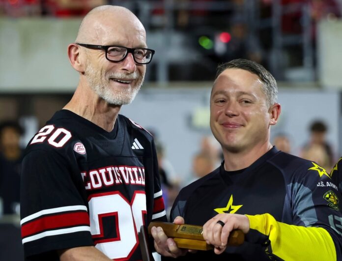 Golden Knights - Bradley_edit Man in football jersey receives baton from Golden Knight