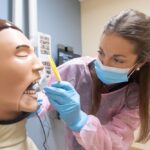 Dental student Katie Hayden works with a dental manikin.