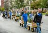 Moving forest helps Louisvillians see how trees can enhance the city UofL’s Urban Design Studio organized The Moving Forest @ PickleY’all to highlight benefits of a greener city People pull wagons with trees and shrubs on the street.